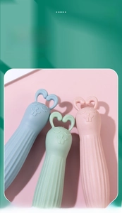 Macro view of cute cartoon bunny hair brushes with heart handles in three colors