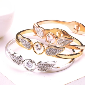 Hollow angel wing bangle with cubic zirconia in gold and silver stainless steel
