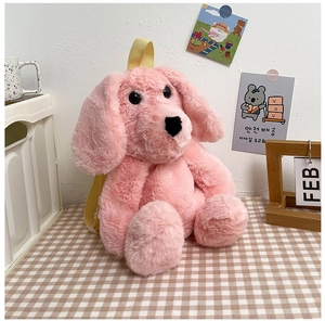 Detail of the soft pink plush dog backpack featuring yellow straps on a checkered table