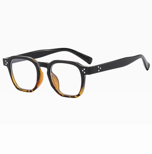 Detail view of oval retro sunglasses with black and amber tortoiseshell dual-tone frame