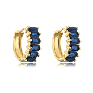 Close-up of 18K gold-plated hoop earrings featuring emerald-cut deep blue zircons