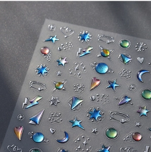 Vista macro di adesivi per unghie 3D con stelle e lune cromate laser brillanti