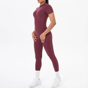 Detail of burgundy short sleeve fitness jumpsuit featuring front zipper and slim fit