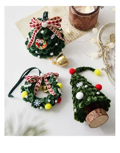 Detailed view of green chenille Christmas tree with golden bells and festive decorations