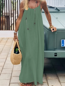 Detail of loose dark green backless cami maxi dress with thin shoulder straps