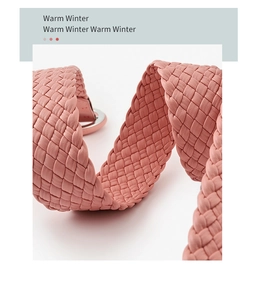 Close-up of pink woven leather belt showing textured details and silver metal buckle