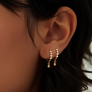 Close-up of gold-plated S925 silver star hoop earrings with sparkling zircon stones