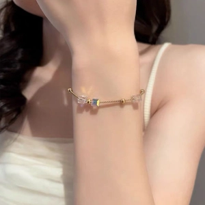 Detail of elegant gold-toned chain necklace with iridescent cube beads worn on a neck