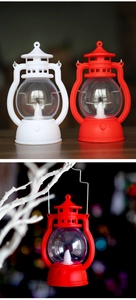 Detail view of retro LED pumpkin lanterns in red and white with top hanging loop