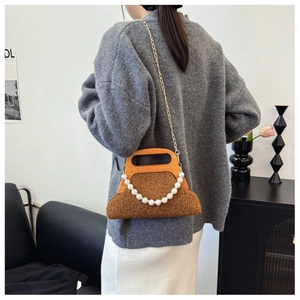 Detail of brown plush handbag featuring vintage wooden handle and pearl chain accent