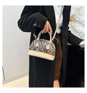 Leopard print shell bag styled with a black blazer for a chic commuting look