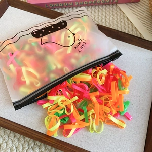 Detail of high-elasticity colorful hair ties in a frosted zipper bag for hair styling