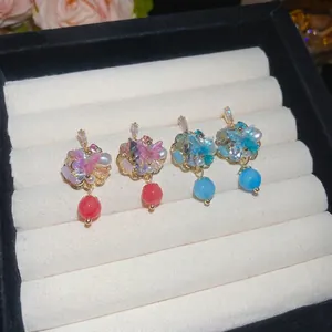 Exquisite butterfly pearl earrings with colorful crystals and floral accents in a jewelry box