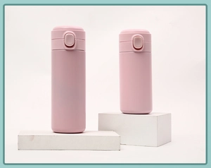 Pink matte stainless steel insulated water bottles in tall and short sizes on white props