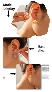 Detail showing spiral shell design earrings in gold and silver plating on a model