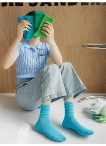 Detail of colorful ribbed crew socks in electric blue and green shades with knit texture