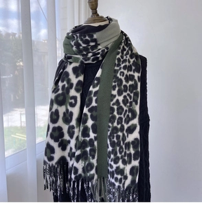 Detail of leopard print scarf with tassels and green color-block on mannequin