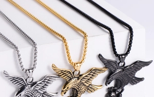 Detailed view of eagle pendants in gold, silver, and black finish with beaded chains