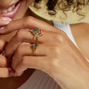 Close-up of S925 silver rings with green moss agate stones on a model's hand