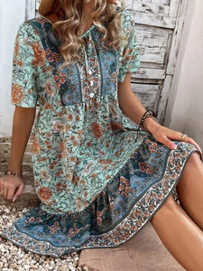 Detail of floral V-neck bohemian dress on model in an outdoor rustic scenery