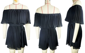 Detail view of black pleated off-shoulder romper with elastic neckline and waist tie