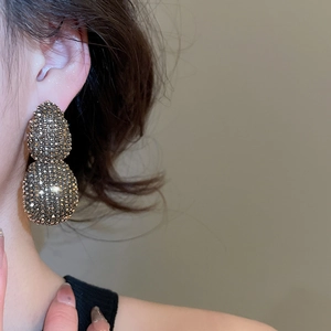 Close-up of vintage gold-tone double ball earrings pavé-set with champagne rhinestones