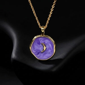 Gold star moon heart pendant necklace with purple enamel swirl on a sleek black stand