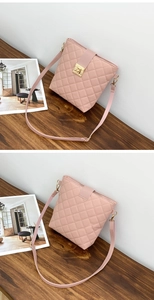 Close-up of pink quilted PU leather bucket bag with golden twist-lock and shoulder strap