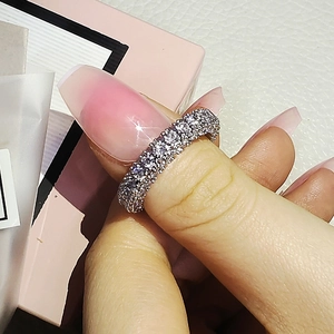 Minimalist silver ring featuring three rows of zircon stones worn on a hand