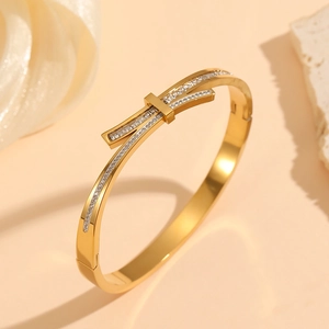 Detail of a thin gold titanium steel bracelet with pavé-set square cubic zirconia stones