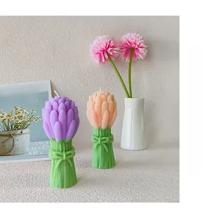 Detailed view of tulip-shaped scented candles with a decorative green bow base