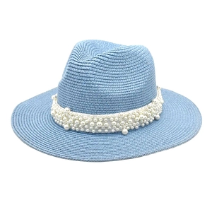 Detailed texture of light blue straw fedora hat featuring elegant white pearl band decor