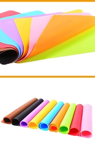 Colorful stack of flexible silicone placemats showing durability and various vibrant colors