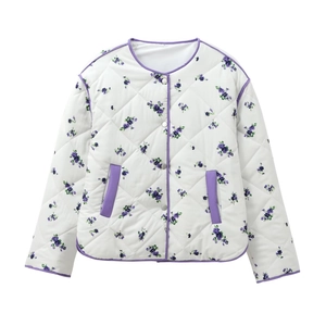 Detail of white quilted jacket featuring purple floral print and round neckline
