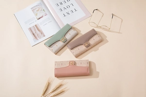 Detail of PU leather long wallets with floral print and gold metal logo decoration