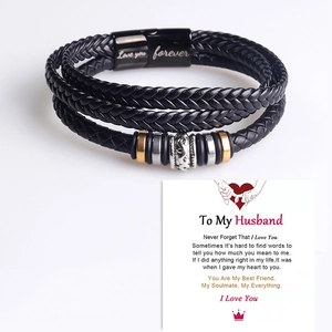 Detail of triple-layer braided leather bracelet with engraved magnetic clasp on gift card