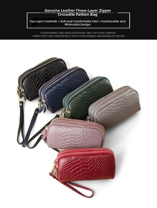 Detail view of multi-color genuine leather clutches with embossed crocodile pattern
