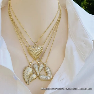 Close-up of four assorted 18K gold plated heart necklaces with sparkling cubic zirconia