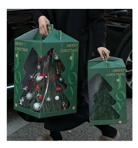 Detail of Christmas tree gift box with transparent window being carried by a person
