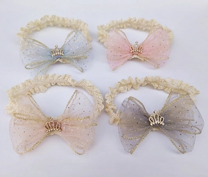 Detailed view of four lace baby headbands with glittery mesh bows and golden crowns