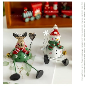 Detailed view of Christmas iron reindeer and snowman figurines with long wire legs