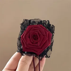 Detailed view of handmade dark red lace rose hair accessory and choker necklace