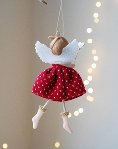 Detail of red polka dot angel doll hanging ornament with soft white wings and tassel fringe