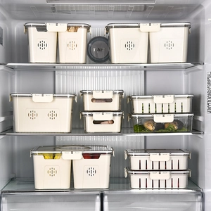 Set of beige PET food storage containers with lids and vents organized in a refrigerator