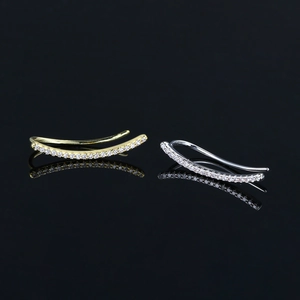 Sparkling crystal ear crawler earrings with lightning bolt and angel eye motifs in gold and silver