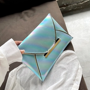 Detail of holographic envelope clutch with gold metal trim and iridescent laser finish