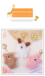 Close-up of soft plush puppy keychains in white, brown and pink with golden metal rings