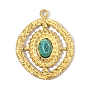Macro view of vintage gold pendant with green textured stone and woven metal details