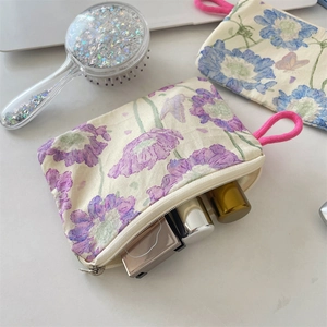 Floral print makeup bag showing practical storage for lipstick and beauty tools