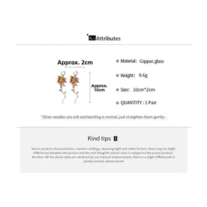 Detail view of 10cm bohemian long tassel earrings with orange glass leaves and silver needles